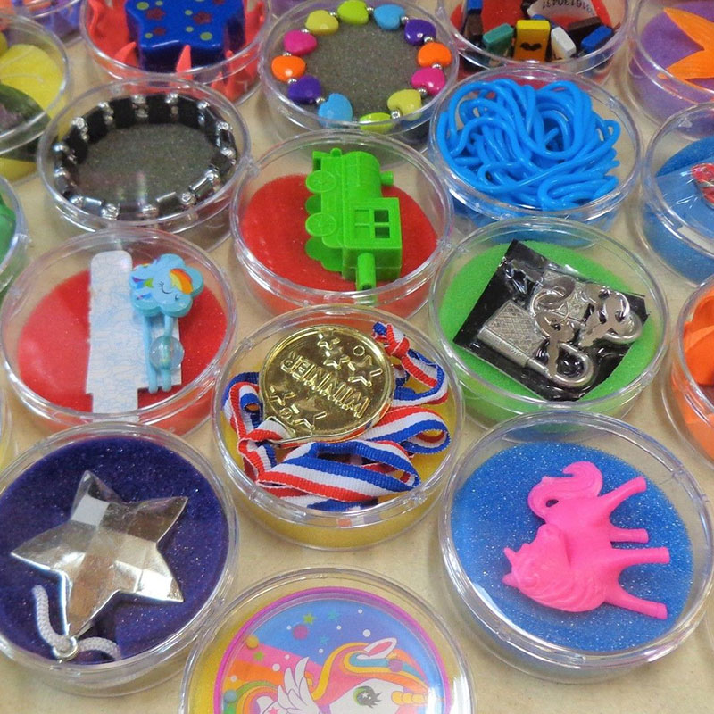 arcade prizes in round plastic box